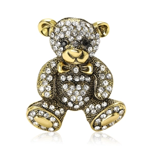 Sparkling gold teddy bear brooch with white rhinestones and a heart shape for suits