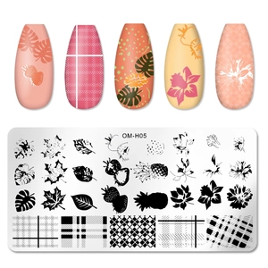 Macro detail of rectangular nail stamping plate with tropical leaves and fruit patterns