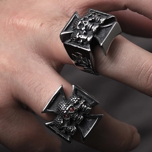Detailed close-up of men's stainless steel gothic rings with skull and cross patterns