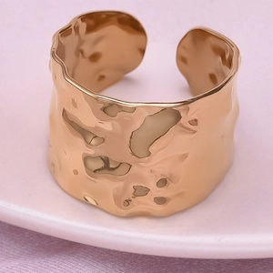 Detailed view of wide gold 304 stainless steel ring with unique hammered texture