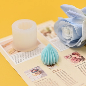 Macro view of blue wave textured candle and the translucent white silicone DIY mold