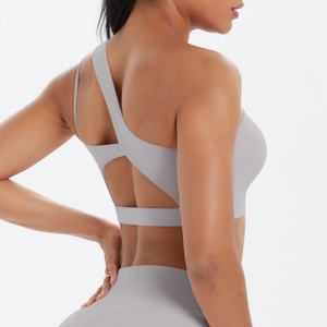 Detail view of light grey asymmetric single shoulder sports bra with hollow back design