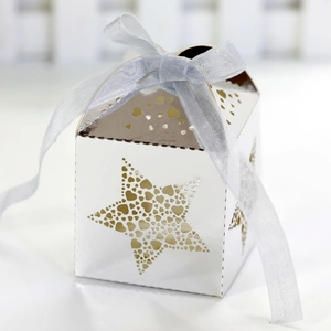 White laser cut gift box with star and heart patterns and a light blue ribbon bow