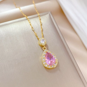 Close-up of teardrop pink stone pendant with pavé crystals on a gold steel chain