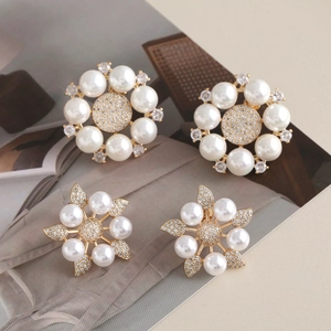 Elegant geometric gold pearl earrings with sparkling crystals in floral camellia design