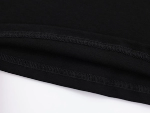 Macro shot of double-needle stitching on black modal sports t-shirt hem and sleeve cuffs