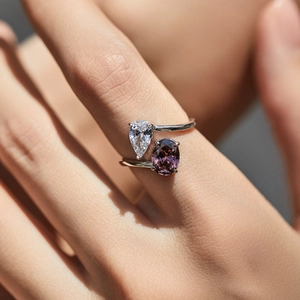 S925 sterling silver interlaced ring featuring a pear-cut clear gem and purple oval stone