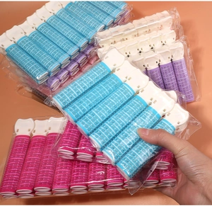 Close-up of portable hair volume clips in blue, pink and purple for styling