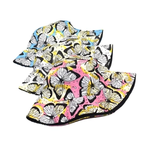 Reversible bucket hat with butterfly print in blue, white, and pink for outdoor sun protection