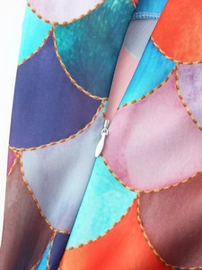 Detailed close-up of mermaid scale print fabric with a white invisible zipper closure