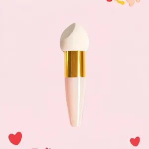 Detail of angled makeup sponge with pink handle and golden ferrule for blending