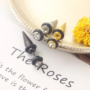 Detail of cone stud earrings in black, silver and gold with sparkling crystals on tray