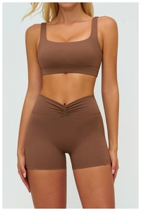 Detail of high-waist sports shorts with a V-shaped ruched waist design in brown matte