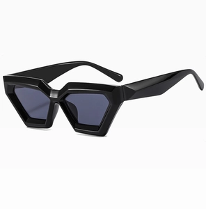 Detail of black geometric polygon sunglasses with thick frames and dark grey lenses