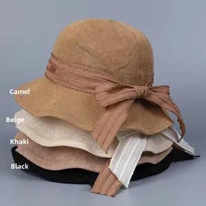 Stack of breathable mesh knit sun hats in camel, beige, khaki, and black with bow ribbons