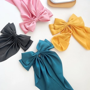 Set of four large silk bow hair clips with long ribbons in pink yellow black and teal