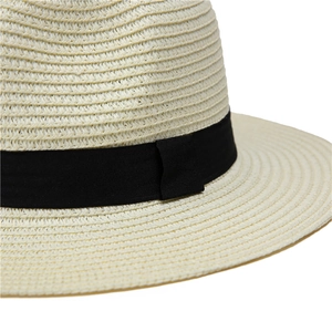 Close-up of the fine woven texture and black ribbon detail on this beige straw sun hat