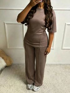 Detail showing the front seam design on brown short sleeve top and wide leg pants set