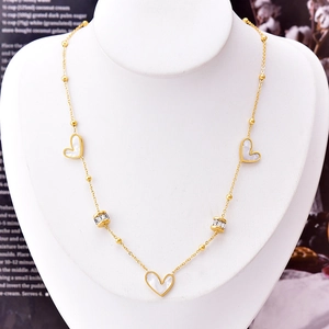 Elegant gold titanium steel necklace featuring white shell hearts and zircon accents