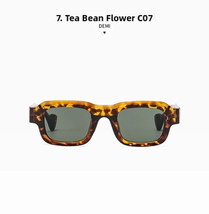 Detailed close-up of retro rectangular demi frames and dark green lenses of sunglasses