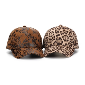 Detail view of two baseball caps featuring dark brush stroke and classic leopard prints
