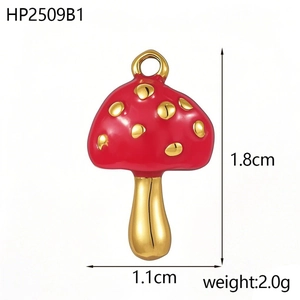 Macro shot of 1.8cm red mushroom pendant with gold dots and polished metal loop