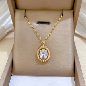 Detail of oval zircon pendant necklace in a luxury beige jewelry gift box presentation