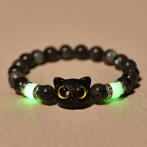 Close-up of cat head charm bracelet with glowing beads and natural grey labradorite