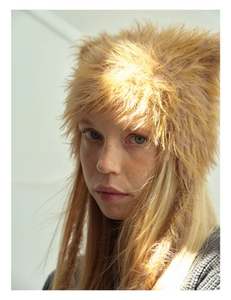 Close-up of fluffy faux fur cat ear hat with soft texture and braided drawstrings