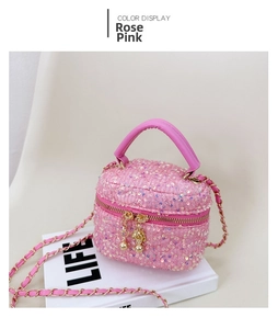 Detail of rose pink sequin quilted bag with leather woven chain and top handle