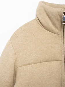 Detail of high-quality knitted stand collar and zipper on beige winter cotton jacket
