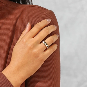 Detail of 18K gold-plated stainless steel ring with black and white checkerboard enamel
