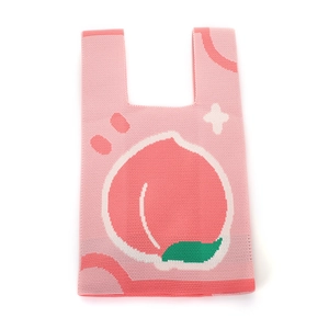 Pink knitted tote bag featuring a peach jacquard pattern on a soft fabric surface