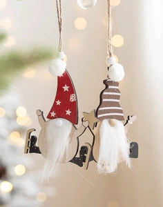 Close-up of wooden Christmas gnomes with plush beards on a festive bokeh background
