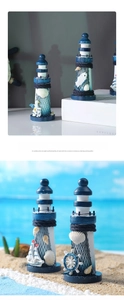 Blue and white wooden lighthouse ornaments with seashells and nets on a beach setting