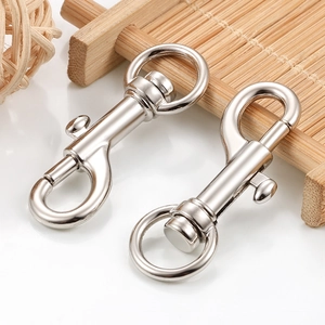 Close-up of swivel spring dog clasps in polished silver finish on white background