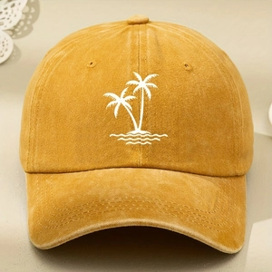 Detail of palm tree embroidery on a ginger yellow washed cotton adjustable baseball cap