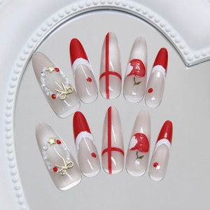 Christmas cat eye press-on nails with red French tips and 3D bow pearl accents