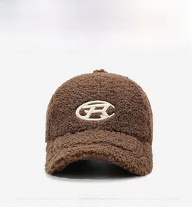 Detailed close-up of dark brown teddy fleece baseball cap with white R embroidery