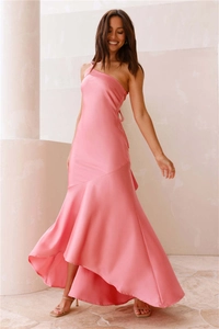 Detail of elegant pink one-shoulder satin dress with silky texture and ruffled mermaid hem