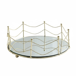 Round gold mirrored tray with elegant wavy double-chain rail and spherical metal feet