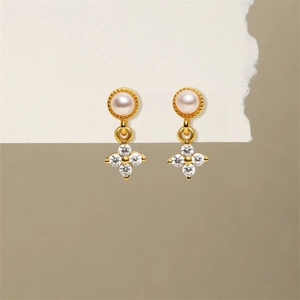 Detailed macro view of S925 silver gold teardrop earrings with white pearls and zircons