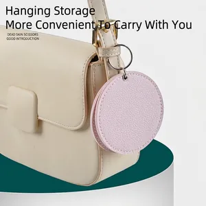 Pink PU leather round pouch for dead skin scissors hanging on a handbag strap