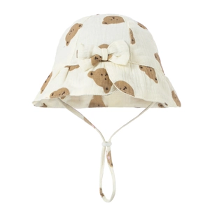 Macro detail of beige cotton baby sun hat with brown bear prints and bow decoration