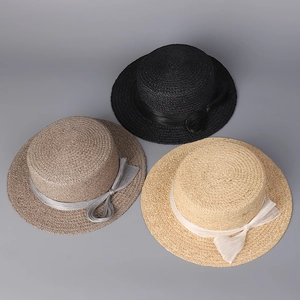 Flat top boater hats with elegant silk ribbons and bows in black and beige colors