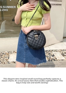 Outdoor shot of a black quilted round bag with metallic bird pendants on a model