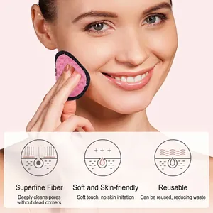 Pink microfiber makeup remover puff with black trim shown in use for face cleaning
