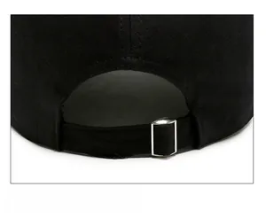 Detail of adjustable metal buckle and twill cotton strap on back of black baseball cap