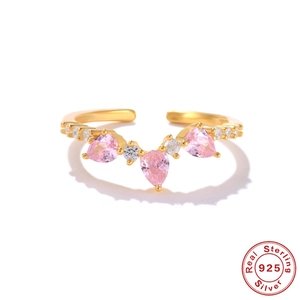 Detail of adjustable S925 sterling silver ring with pink pear-cut gemstones and gold plating
