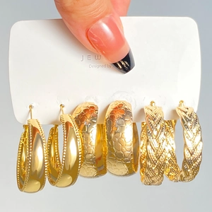 Detailed shot of 3 pairs of gold-plated geometric hoop earrings with textured finishes